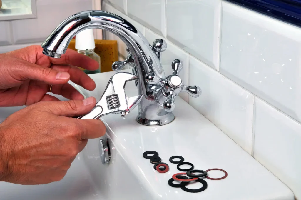 Plumber performing maintenance on a bathroom faucet in Fort Lauderdale