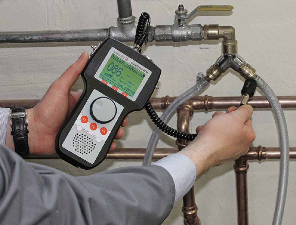 Plumber testing pipes with electronic leak detection equipment in Fort Lauderdale
