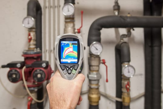 Plumber using a thermal imaging camera to inspect pipes in Fort Lauderdale