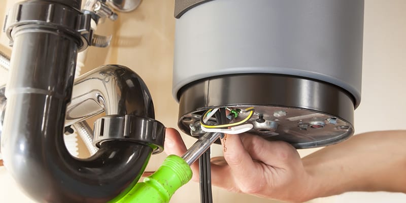 Technician repairing the heating element of a water heater in Fort Lauderdale