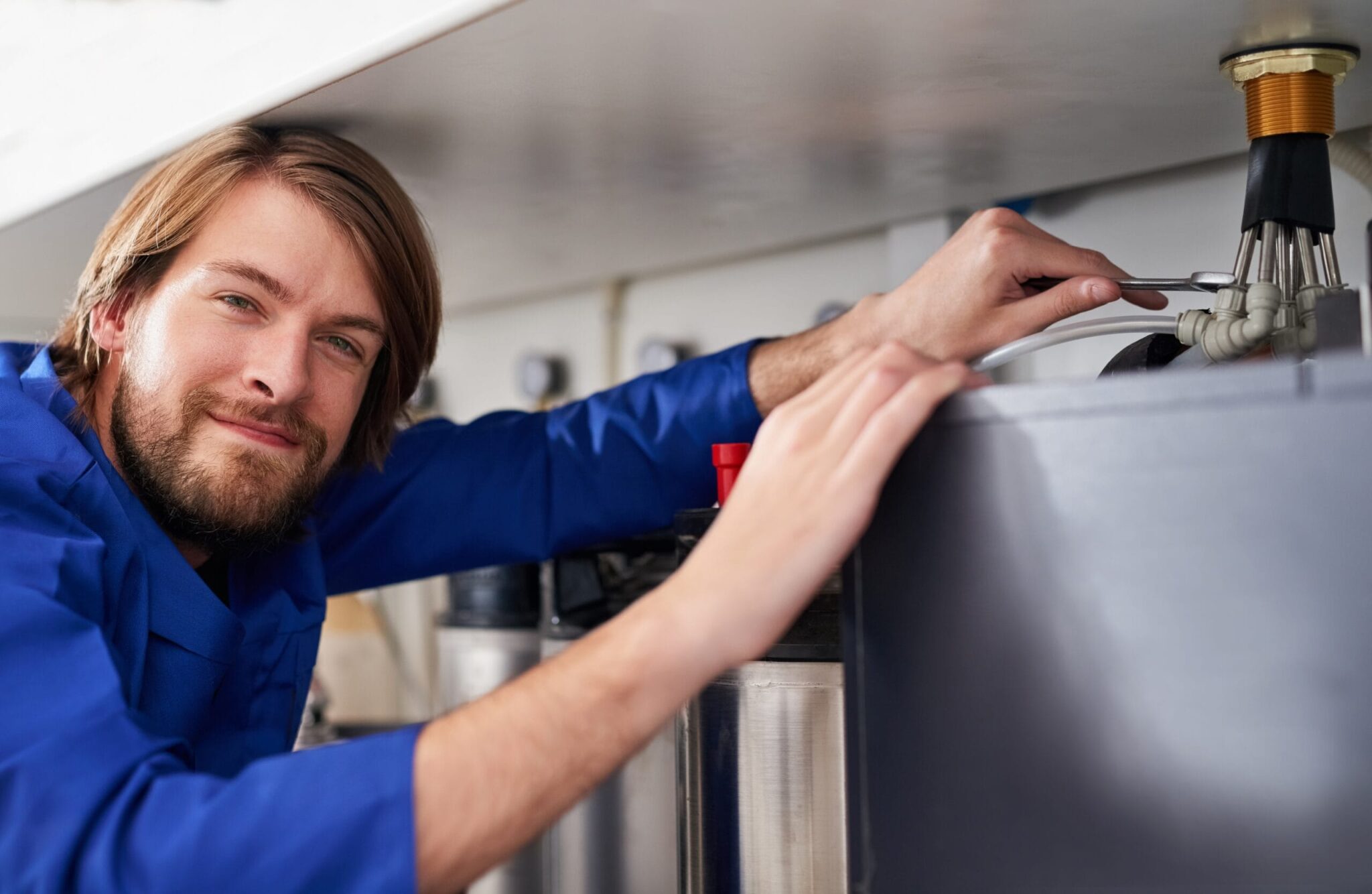 Technician servicing a residential water heater tank in Fort Lauderdale