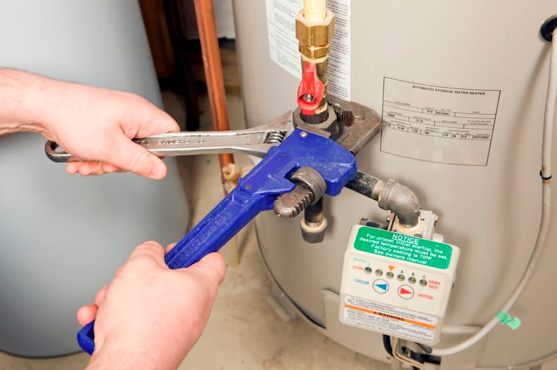 Plumber repairing a water heater valve in Fort Lauderdale